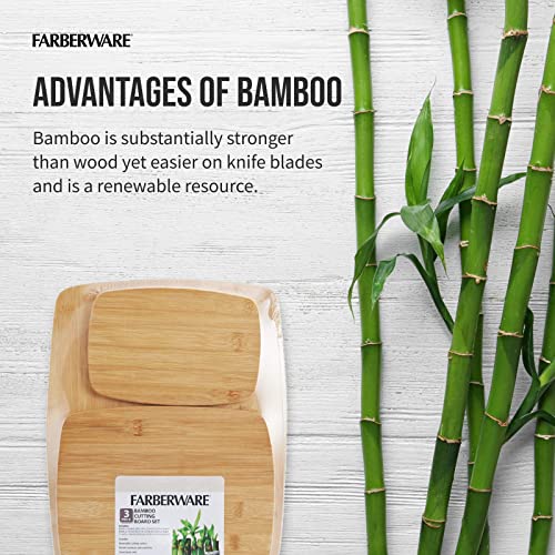 Close-up of Farberware bamboo boards beside green bamboo stalks.