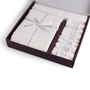 Elegant white tablecloth set with a matching runner and six napkins, beautifully packaged in a gift box with a ribbon.