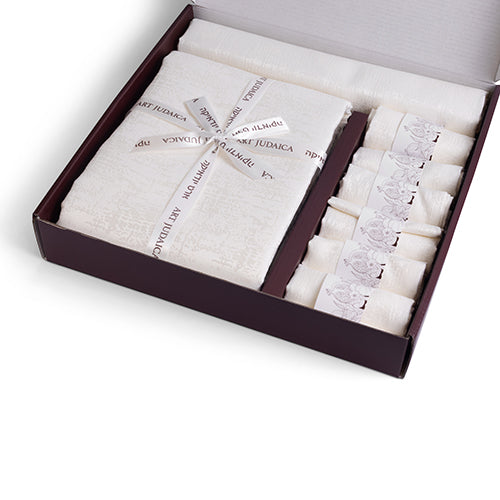 Elegant white tablecloth set with a matching runner and six napkins, beautifully packaged in a gift box with a ribbon.