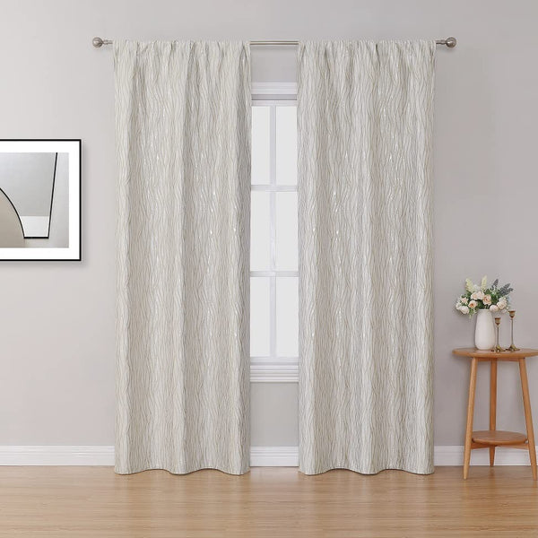 A full-length view of the 42x63 jacquard window curtains hanging on a rod in a bright living room setting.
