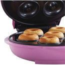 Angled close-up of donut maker with golden mini donuts in the front row