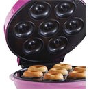 Open Courant donut maker filled with mini donuts on the heating plate
