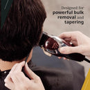 Barber using the Wahl Magic Clip on a client for bulk hair removal and tapering.