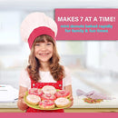 Child holding a plate of decorated mini donuts with the Courant donut maker in the background.
