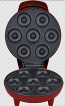 Close-up of the donut maker's nonstick molds arranged to bake seven donuts at once.