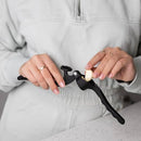 Black handheld garlic press shown on a white background
