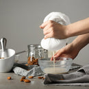 Pouring liquid through Foxrun cheesecloth for fine straining