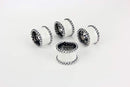 Set of silver-toned napkin rings with textured beaded design