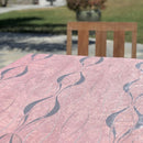 Pink Pearl tablecloth elegantly spread over a large dining table, highlighting its scalloped edges and jacquard texture.