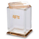 Angled view of crystal tzedakah charity box showing ribbed sides and gold detailing