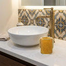 lucite wash cup on a bathroom counter near a sink