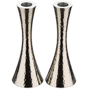 Pair of hammered aluminum candlesticks on a white background