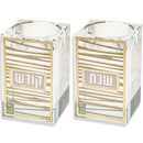 pair of crystal candlesticks with laser cut gold plaques that have a striped design with one saying 'shabbat' and one saying 'kodesh' in hebrew, on a white background 