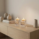 pair of crystal candlesticks on a wooden counter