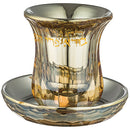 clear and gold crystal kiddush cup  with a saucer on a white background