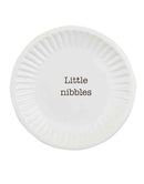 A round, white ceramic tapas plate available in various styles, featuring a unique rim texture (beaded or pleated) and a humorous black phrase.
