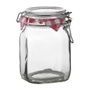 An empty, clear glass Fido jar with a glass lid and a metal wire clamp closure for an airtight seal.