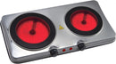 A silver, stainless steel, portable double burner cooktop. It has two circular black ceramic glass heating plates that are glowing red. There are two control knobs and two red indicator lights on the front panel.