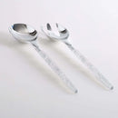 White and silver glitter plastic serving fork and spoon set displayed on a white background.