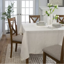 Light-colored tablecloth with a visible weave, showing how it falls over the edge of a surface.