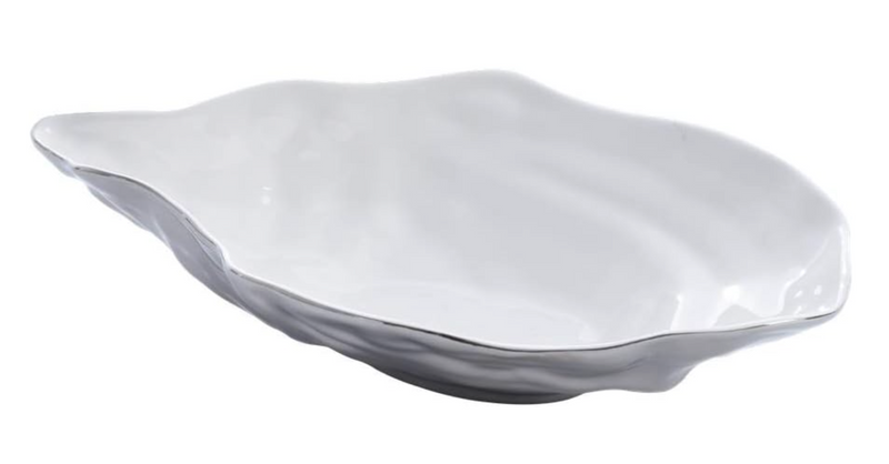 Stunning large serving bowl from Pampa Bay's Oyster collection, crafted from porcelain with a smooth white inside, a textured gray outside, and a fine silver accent on the edge.