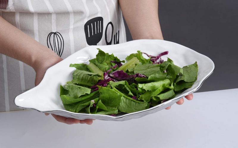 Stunning large serving bowl from Pampa Bay's Oyster collection, crafted from porcelain with a smooth white inside, a textured gray outside, and a fine silver accent on the edge.