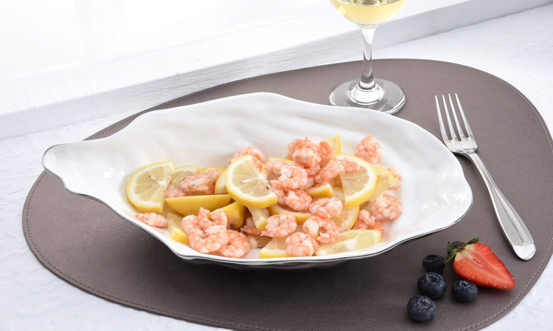 Stunning large serving bowl from Pampa Bay's Oyster collection, crafted from porcelain with a smooth white inside, a textured gray outside, and a fine silver accent on the edge.