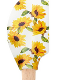 Close up of the spatula head, adorned with sunflower pattern, against a white background