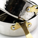 A stacked set of six small, shallow, hammered stainless steel mini frying pans with long, thin gold-colored handles.