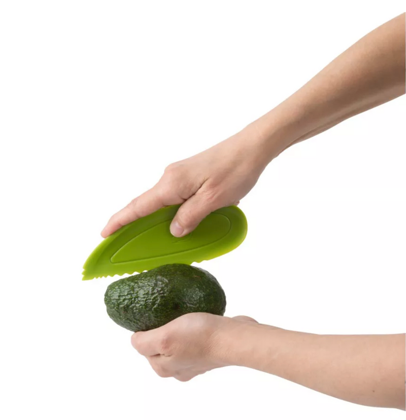 A lime green Trudeau Maison avocado slicer, with a serrated edge for cutting, a pit remover, and a fan-slicing end.
