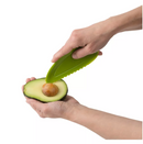A lime green Trudeau Maison avocado slicer, with a serrated edge for cutting, a pit remover, and a fan-slicing end.