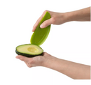 A lime green Trudeau Maison avocado slicer, with a serrated edge for cutting, a pit remover, and a fan-slicing end.
