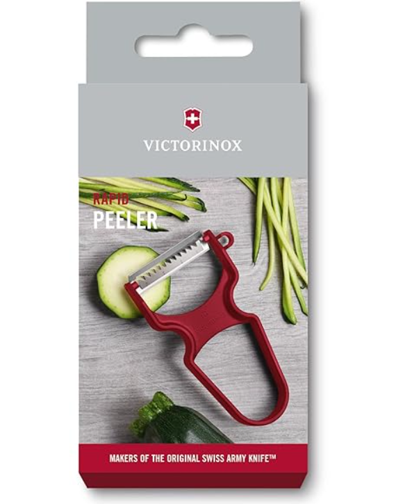 Red Victorinox Rapid Peeler and Shredder with stainless steel blade and built-in bud remover displayed in its retail packaging on a white background.