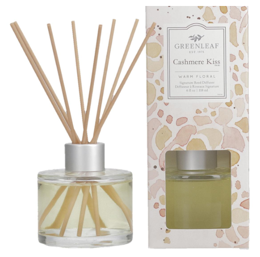 4oz Cashmere Kiss reed diffuser in a clear glass bottle with fiber reeds on a white background.