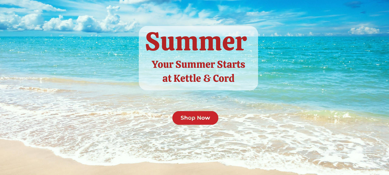 Beach scene with turquoise waves and a bright blue sky, overlaid with bold red text that says “Summer – Your Summer Starts at Kettle & Cord,” and a red “Shop Now” button below.

