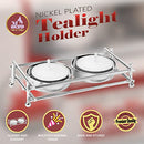 A boxed set featuring a shiny, rectangular, nickel-plated metal frame holder designed for two mini tealight candles, with two white tealights included.