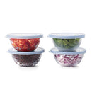 The OXO Good Grips 8-Piece Glass Prep Bowl Set is displayed with four glass bowls stacked, each containing chopped cilantro, tomatoes, black beans, and diced red onion, respectively, and sealed with a light blue silicone lid. A fifth open glass bowl with diced red onion and a separate lid are shown in the foreground.