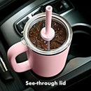 A tall, matte black OXO Strive XL tumbler with a clear lid, a black straw inserted, and a sturdy black handle on the side. The white OXO logo is visible on the tumbler's body.