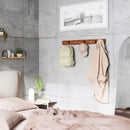 Walnut and black Umbra Flip 8-Hook wall-mounted coat rack with retractable hooks on a white background.