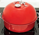 A round, red metal stovetop smoker with a high-domed lid, a built-in thermometer, and silver side handles.