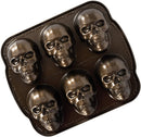 Nordic Ware bronze skull-shaped cakelet pan with six detailed cavities on a white background.