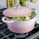 Blush pink cast iron Dutch oven with lid.