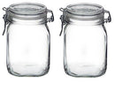 Two empty, clear glass Fido jars, each with a glass lid and a metal wire clamp closure for an airtight seal.