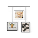 A modern black frame photo display featuring three frames suspended from a horizontal bar by thin rods.