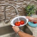 Large, round gray and white collapsible colander.