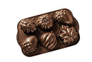 A bronze-colored cast aluminum baking pan with six cavities molded into various autumn shapes, including pumpkins, acorns, and oak leaves.
