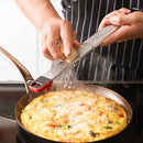 A long, narrow stainless steel grater with two grating surfaces. The top half features fine grating holes, and the bottom half has coarse holes. The grater has black handles on both ends, with one handle having a red accent.