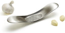 A sleek, stainless steel garlic press with a unique curved shape and perforated crushing surface.