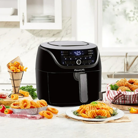 A black air fryer with a digital display, a basket filled with crispy golden fries.