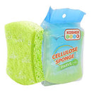 A vibrant green rectangular cellulose sponge is displayed alongside its translucent green and white packaging. The packaging features the "Kosher Cook" logo, "CELLULOSE SPONGE," and "PARVE" labels.